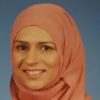 Photo of Zaira Khanum's head, smiling in a peach headscarf