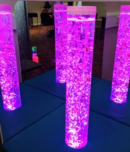 Image shows 4 pink lava lamps in the quiet/sensory room at IDODP 2023.